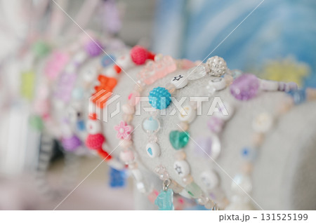A collection of children's beaded bracelets with cute figures and hearts. 131525199