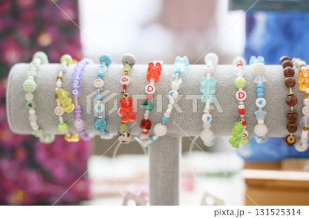 Handmade jewelry: bracelets with resin bears and bright beads at the fair 131525314