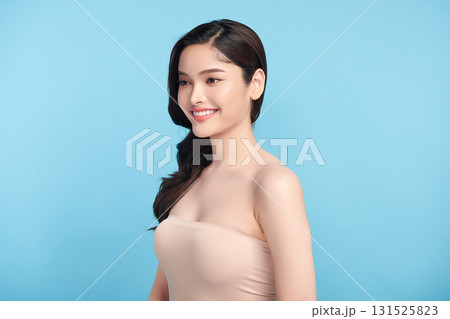 Beautiful Young transgender woman with clean fresh skin on blue background, Face care, Facial treatment, Cosmetology, beauty and spa, transgender women portrait. Beautiful Young transgender woman with clean fresh skin on blue background, Face care, Facial treatment, Cosmetology, beauty and spa, transgender women portrait. 131525823