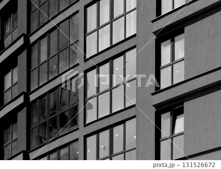 Close up of modern high rise tower. Multiple glass windows and balconies create contemporary Close up of modern high rise tower. Multiple glass windows and balconies create contemporary 131526672