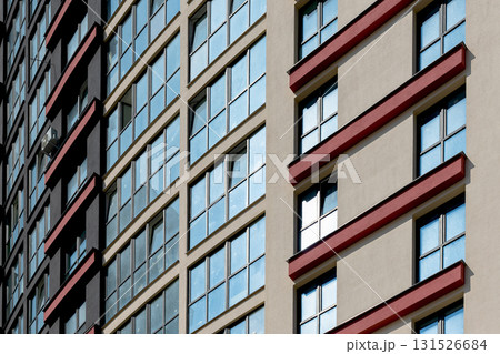 Close up of tall high rise residential building. Multiple windows and balconies create geometric Close up of tall high rise residential building. Multiple windows and balconies create geometric 131526684