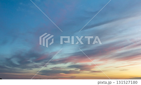 Colorful sunset skies filled with clouds over a tranquil horizon during the evening hours Colorful sunset skies filled with clouds over a tranquil horizon during the evening hours 131527180