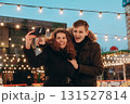 A young couple in love hugs and takes a selfie on an ice rink 131527814