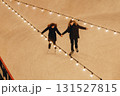 A young couple in love skating, holding hands and smiling, top view 131527815