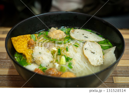 Traditional Thai Noodle Soup with Fish Balls and Crispy Wonton in Black Bowl Traditional Thai Noodle Soup with Fish Balls and Crispy Wonton in Black Bowl 131528514