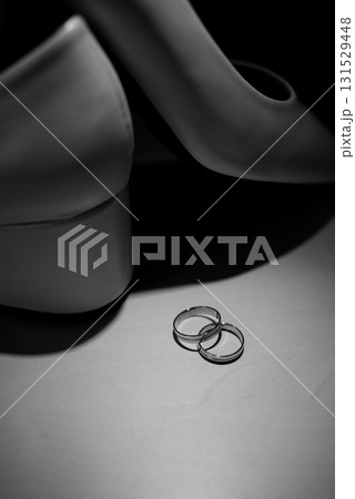 Gold Wedding Rings with White Bridal Shoes Display Gold Wedding Rings with White Bridal Shoes Display 131529448