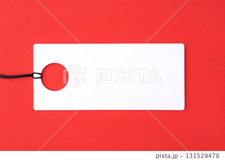 Empty white tag on red background Empty white tag on red background 131529478