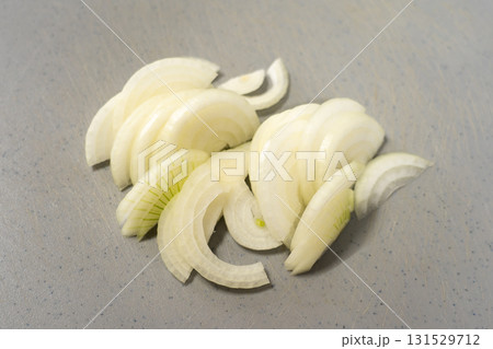 Sliced onions on plastic cutting board Sliced onions on plastic cutting board 131529712