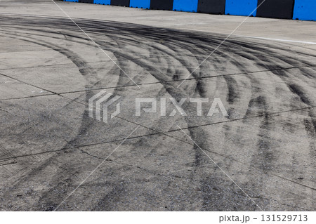 Black tire marks on road, Black rubber tire marks and tread marks, Tire trace track wheels texture and background, Auto tire tread grunge, Car wheel tyre tread track black tyre print. 131529713