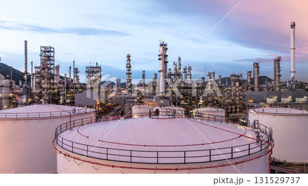 Aerial view oil and gas refinery plant at night, Global business energy logistic transportation, Oil and gas refinery petrochemical industrial, Petrochemical refinery industrial energy supply chain. Aerial view oil and gas refinery plant at night, Global business energy logistic transportation, Oil and gas refinery petrochemical industrial, Petrochemical refinery industrial energy supply chain. 131529737