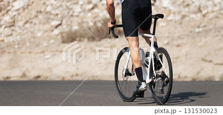 Road bike cyclist man cycling, athlete on a race cycle 131530023