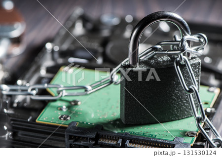 The photo shows a hard disk in chains, suggesting a defense against digital attacks 131530124