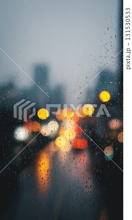 Raindrops On Window With Blurred City Lights In Background. Moody Urban Scene Capturing Rainy Evening Ambiance Raindrops On Window With Blurred City Lights In Background. Moody Urban Scene Capturing Rainy Evening Ambiance 131530533