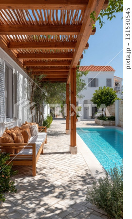Charming Mediterranean Patio With Wooden Pergola And Poolside Seating. Relaxing Outdoor Space For Leisure And Comfort 131530545