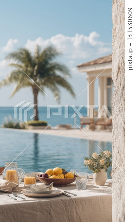 Outdoor Dining Setup By A Pool With Ocean View. Luxurious Tropical Breakfast Scene Outdoor Dining Setup By A Pool With Ocean View. Luxurious Tropical Breakfast Scene 131530609