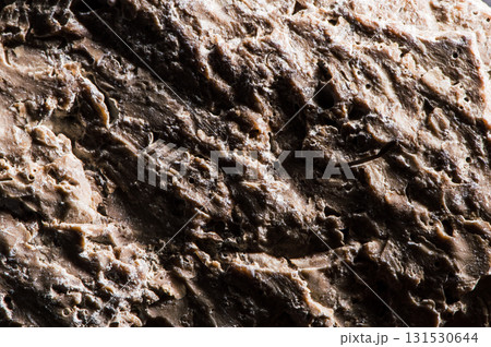 The surface of the stone has a complex texture. The details of the texture are clearly visible in macro photography. The stone looks natural and untouched. Marble, silicon, limestone, sandstone. The surface of the stone has a complex texture. The details of the texture are clearly visible in macro photography. The stone looks natural and untouched. Marble, silicon, limestone, sandstone. 131530644