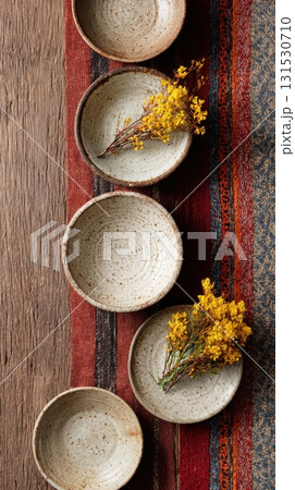Ceramic Bowls With Yellow Flowers On Rustic Wooden Table. Artistic Table Setting With Natural Elements 131530710