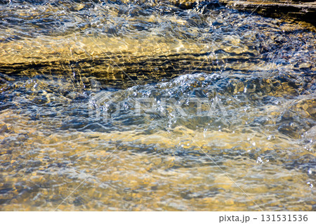 nature texture with stones in the water steam. closeup background of a river shore in autumn nature texture with stones in the water steam. closeup background of a river shore in autumn 131531536