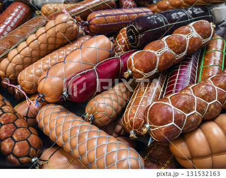 Various types of sausages displayed in a market setting during a vibrant food festival Various types of sausages displayed in a market setting during a vibrant food festival 131532163