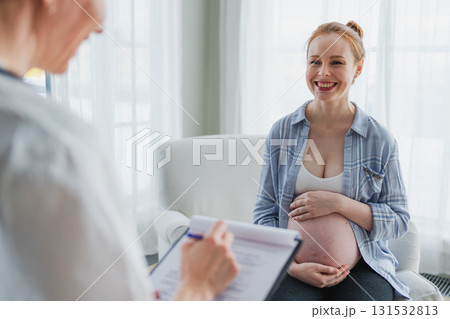 Female doctor examining pregnant woman in doctor office. Pregnant girl patient have consultation in hospital. Gynecologist doctor consulting patient about pregnancy. Visit to doctor medical checkup Female doctor examining pregnant woman in doctor office. Pregnant girl patient have consultation in hospital. Gynecologist doctor consulting patient about pregnancy. Visit to doctor medical checkup 131532813