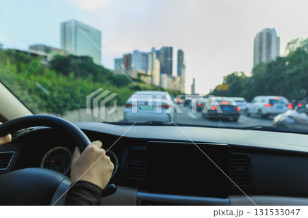 People driving car in modern city People driving car in modern city 131533047