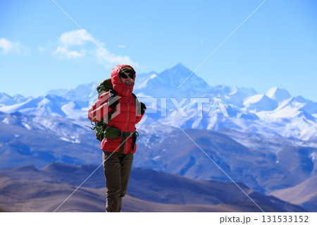 Successful woman hiker hiking to Mount Everest in Tibet, China Successful woman hiker hiking to Mount Everest in Tibet, China 131533152