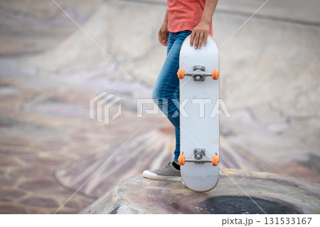 Skateboarder skateboarding at skatepark in city Skateboarder skateboarding at skatepark in city 131533167