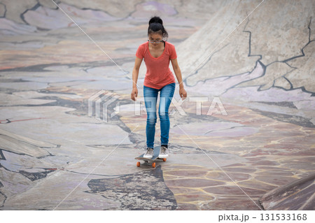 Skateboarder skateboarding at skatepark in city 131533168