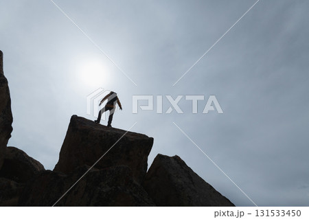 Backpacking woman enjoy the view on high altitude mountain top 131533450