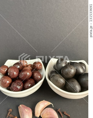 Closeup of green and black olives. Bowls of assorted olives still life. Closeup of green and black olives. Bowls of assorted olives still life. 131533691