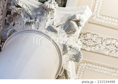 Classical decorative architecture close up photo. Intricate Corinthian capital Classical decorative architecture close up photo. Intricate Corinthian capital 131534499