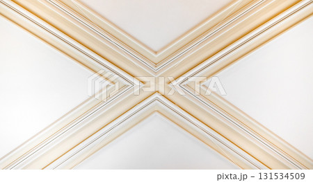 A close-up of decorative architectural molding forming an X-shaped cross 131534509