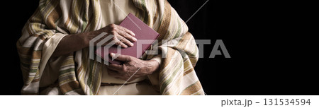 Old man holding a book Old man holding a book 131534594