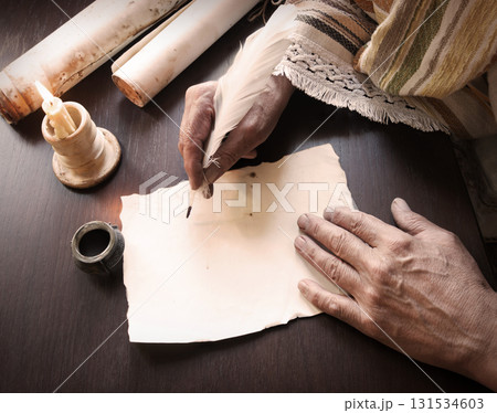 Male hand witn big quill Male hand witn big quill 131534603