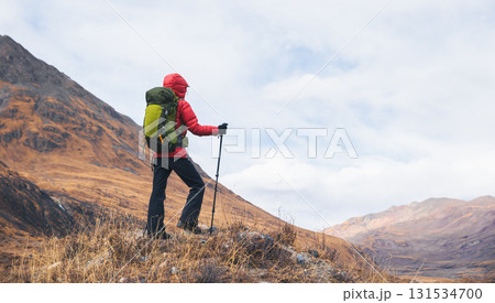 Backpacking woman hiking on winter high altitude mountain top 131534700
