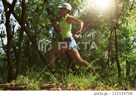 Woman trail runner running at tropical forest mountain peak 131534706