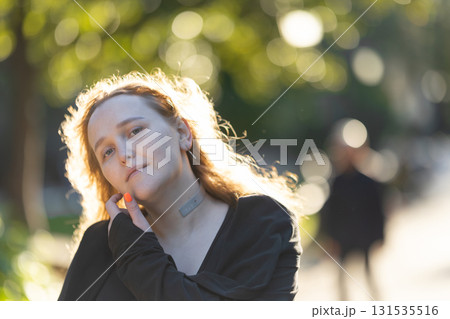 Young woman enjoying warm golden hour sunlight 131535516