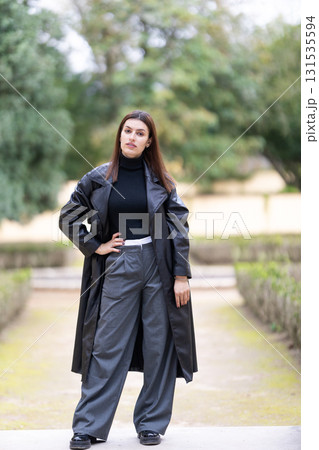 Young woman confidently posing in autumn park Young woman confidently posing in autumn park 131535594