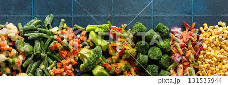 Eye-catching banner with frozen fruits and vegetables, emphasizing the vibrant, seasonal process of freezing healthy produce for winter, ideal for health-related advertisements 131535944
