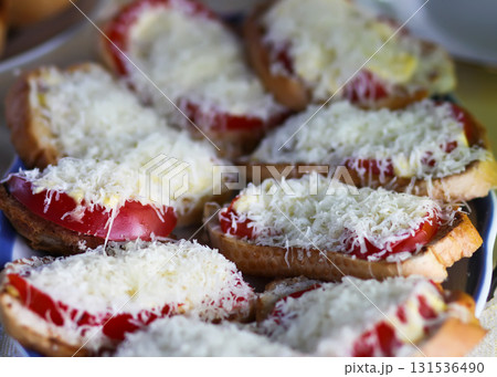 Fried bread topped with melted cheese and tomatoes. Fried bread topped with melted cheese and tomatoes. 131536490
