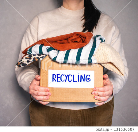 Large box packed with old clothes that are prepared for recycling. Image for Upcycling services. Zero waste concept. Large box packed with old clothes that are prepared for recycling. Image for Upcycling services. Zero waste concept. 131536507