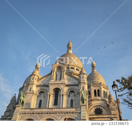 Montmartre sunset view of Sacre Coeur Basilica in Paris with vibrant skies 131536673