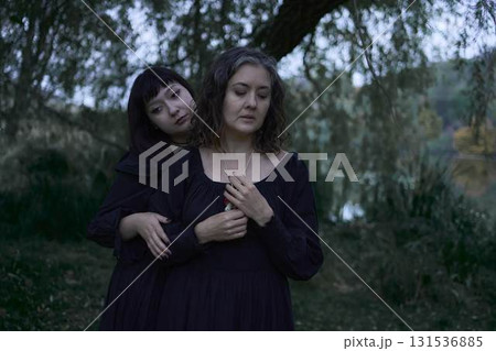 two women in the black long dresses on Halloween, brides of Dracula, vampires, bite, kiss, 131536885