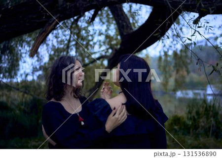 two women in the black long dresses on Halloween, brides of Dracula, vampires, bite, kiss, 131536890