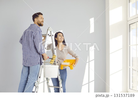 Smiling married young couple doing renovations at home 131537189
