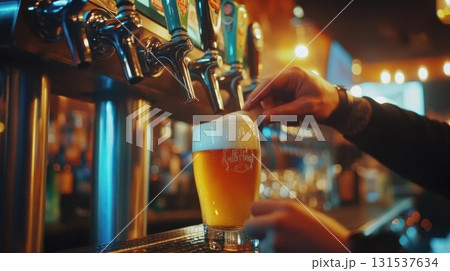 Barman pouring beer into a pint at night club or pub. 131537634