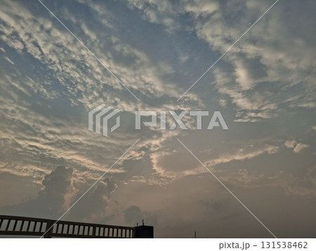 Dramatic, wispy clouds illuminated by soft sunset light, creating a serene and ethereal sky scene Dramatic, wispy clouds illuminated by soft sunset light, creating a serene and ethereal sky scene 131538462