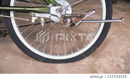 Close up of flat bicycle tire on concrete road Close up of flat bicycle tire on concrete road 131538534