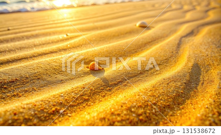 Close-up view of smooth golden sand dunes with gentle ripples and small scattered rocks under bright sunlight in a vast desert landscape du daytime 131538672