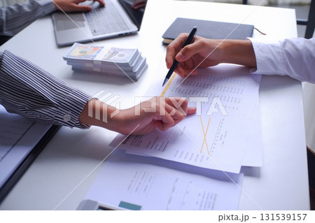 Two businesspeople, banker, account working together in office desk, calculating, counting money, analyze data 131539157